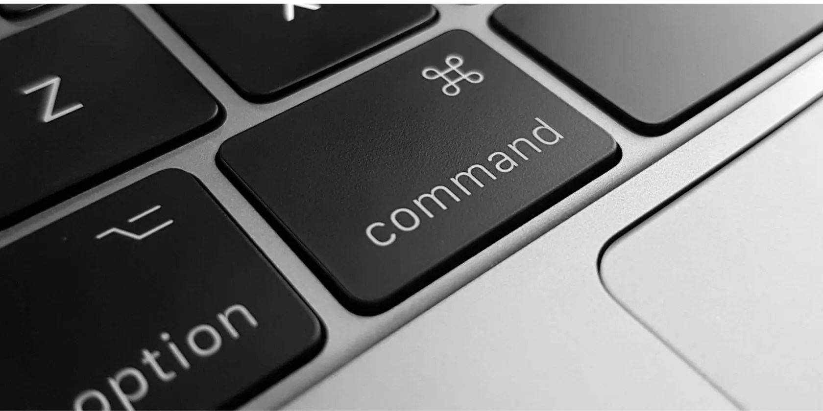 Close-up of the Command key on an Apple MacBook keyboard