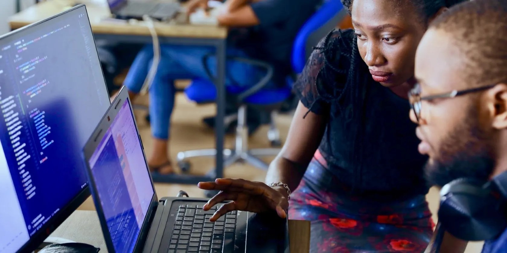 A man and a woman using a laptop