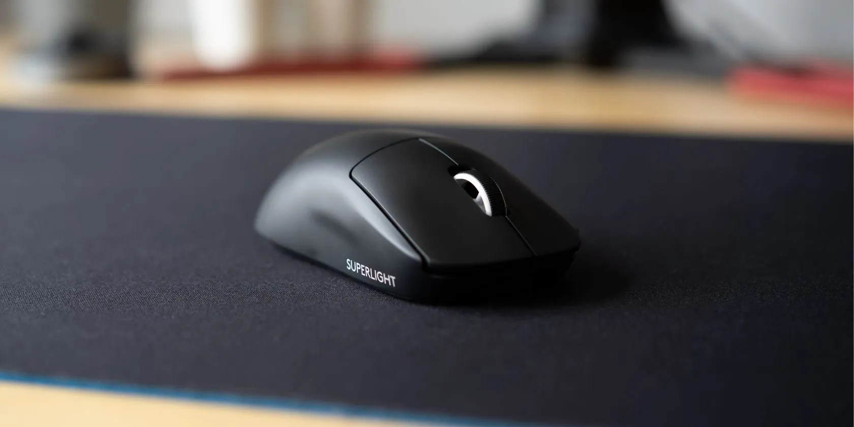 Black Logitech G Pro X Superlight mouse on a mousepad