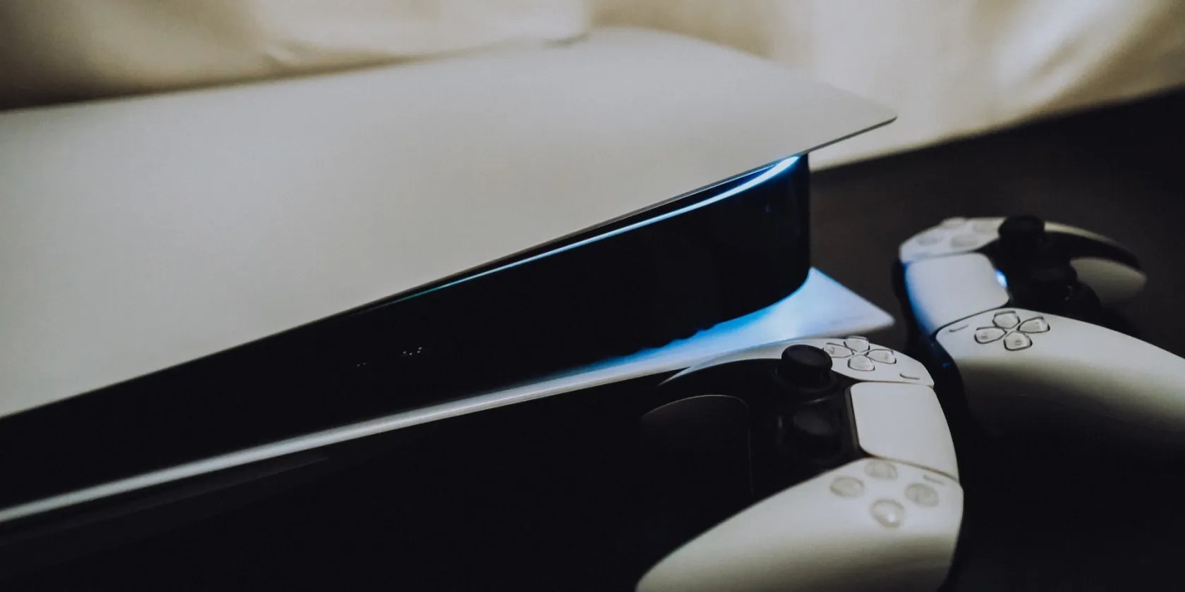 A PS5 with two DualSense controllers