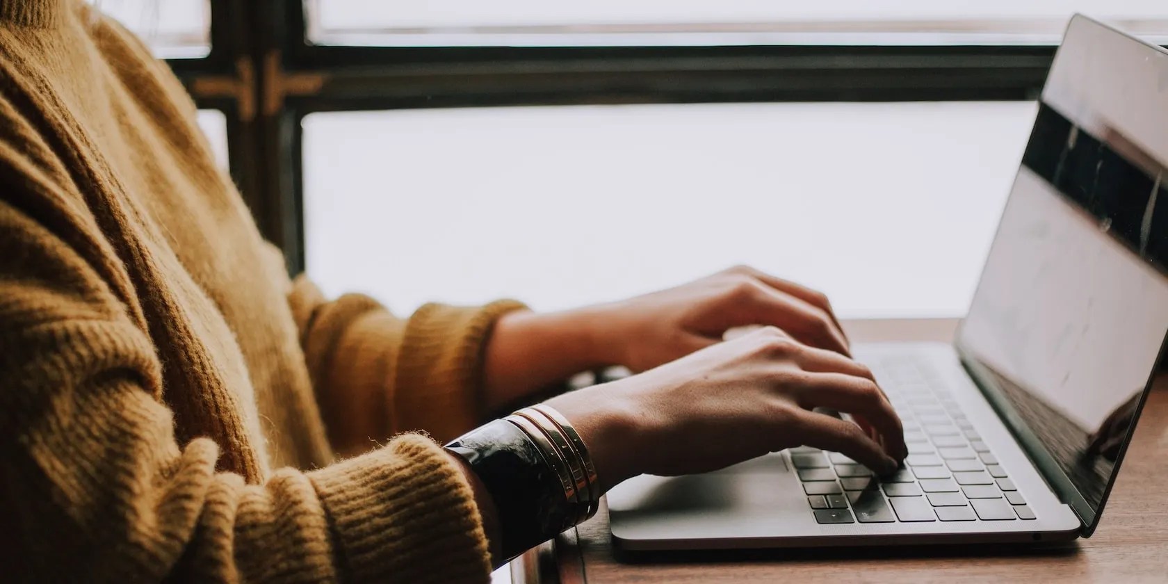 Woman Typing on Laptop