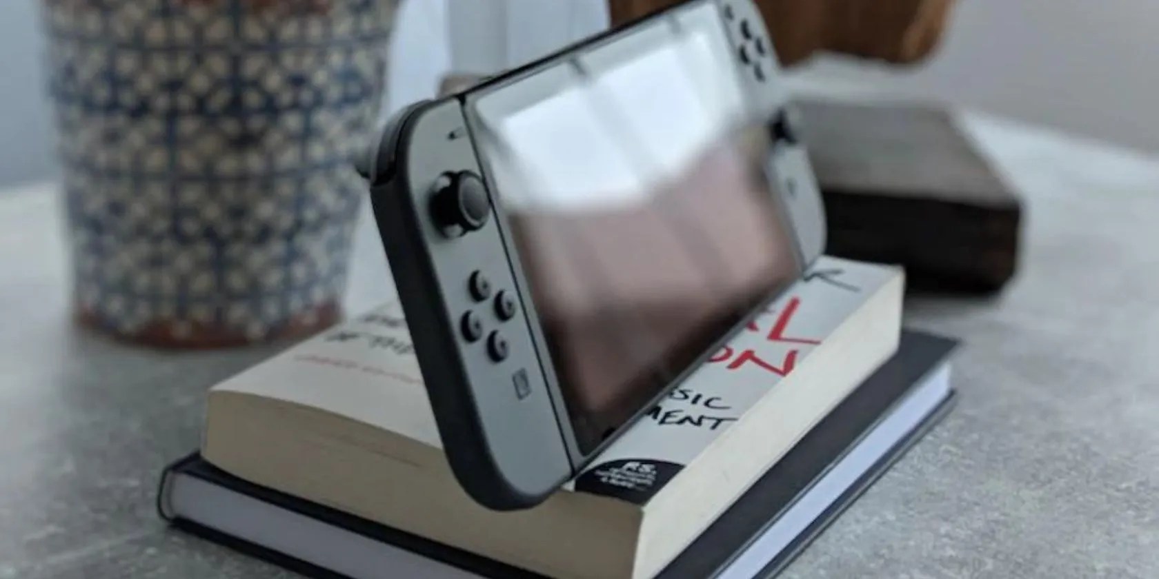 A Nintendo Switch on a stack of books