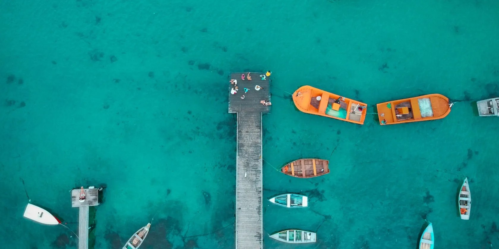 overhead view of a dock surrounded by small boats
