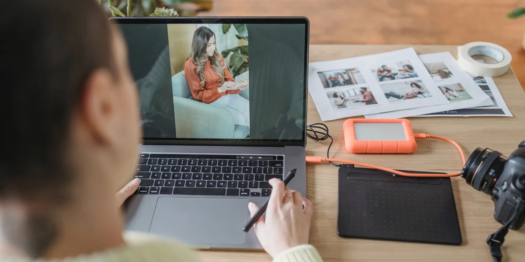 Person looking at a photo on a Macbook.