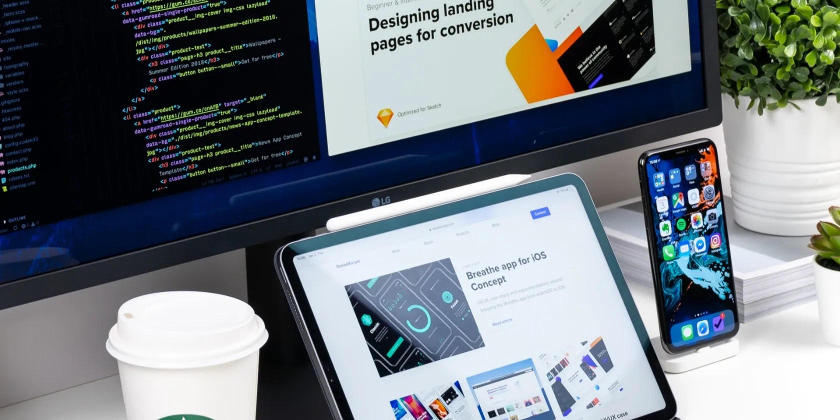 A laptop, phone, and desktop being used for web development