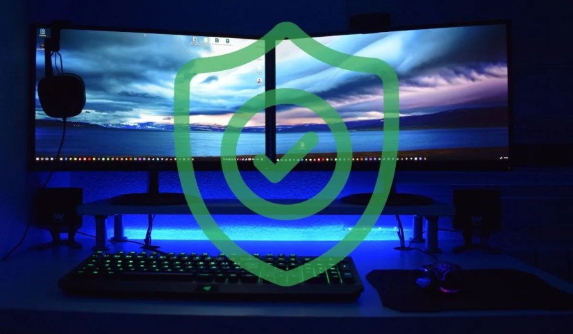 Security symbol seen over a phot of two screens and a computer