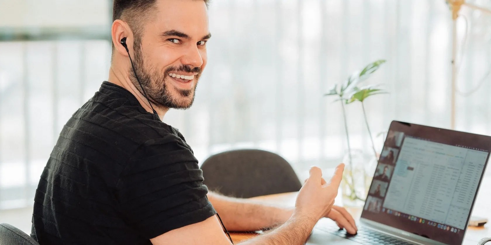 Smiling Man on a Laptop