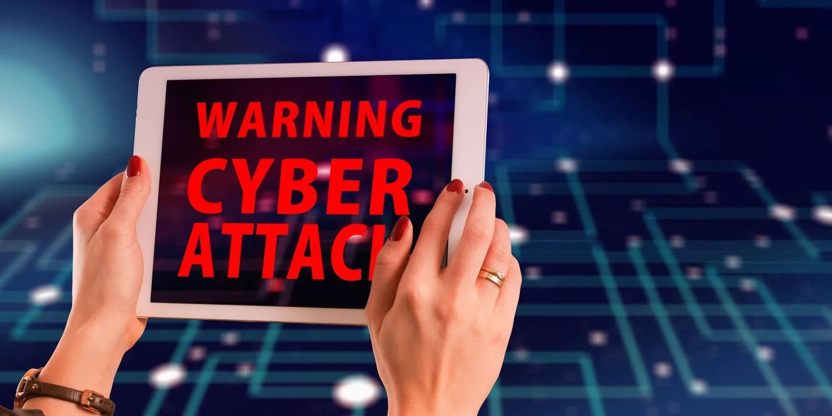 cyber attack warning on tablet held by woman