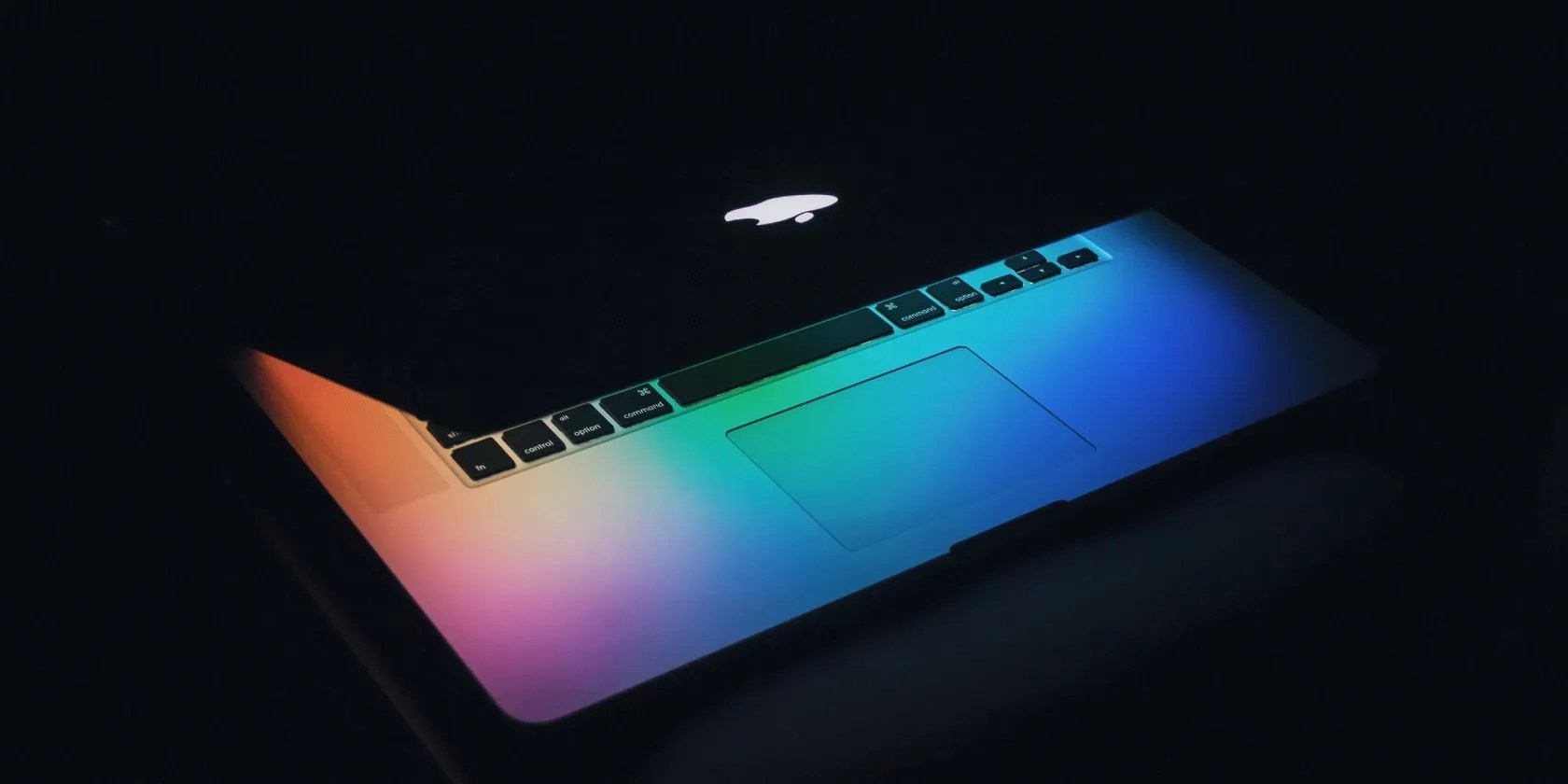 macbook half open in dark room