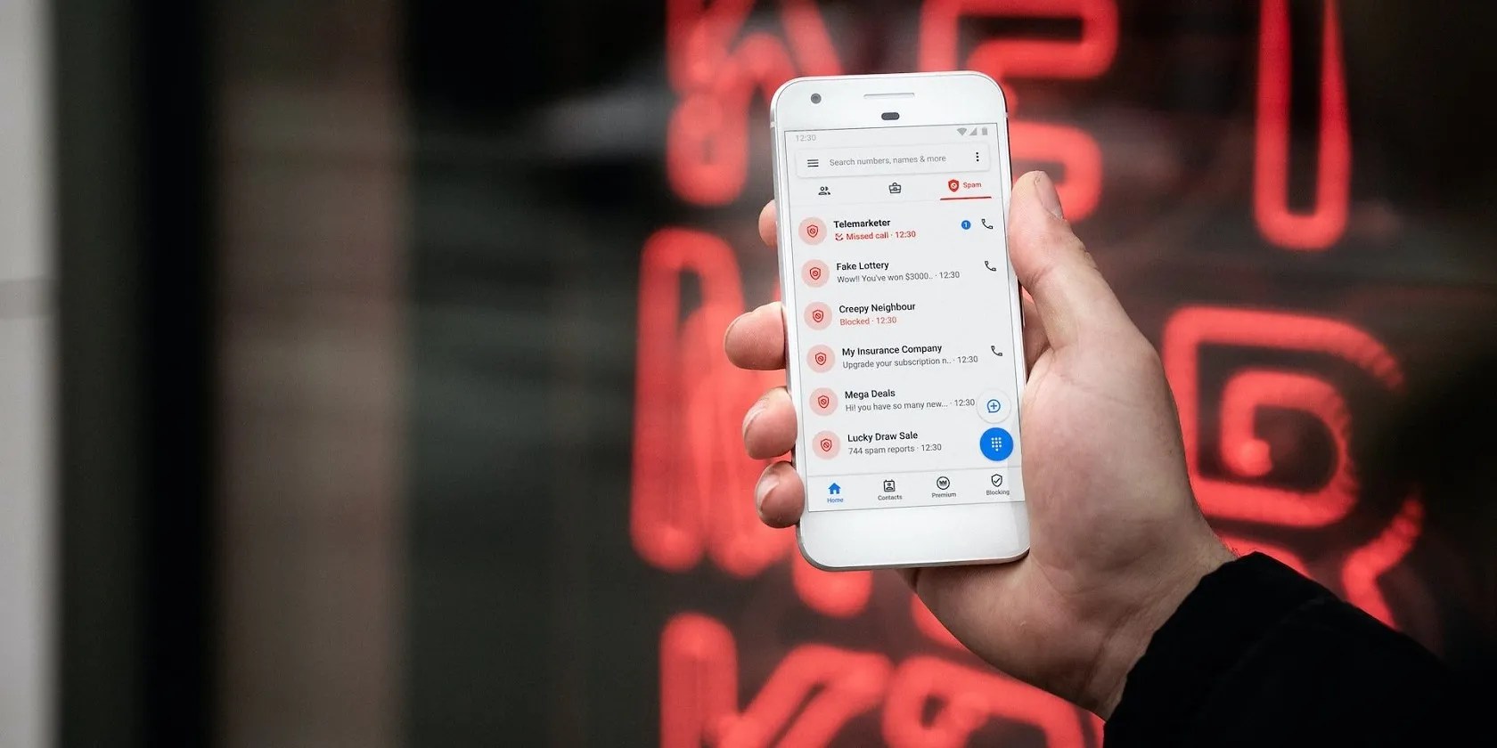 A hand holding a phone displaying a record of calls and messages