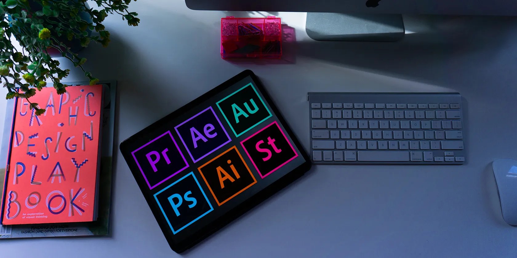 photo showing different adobe program logos next to a computer