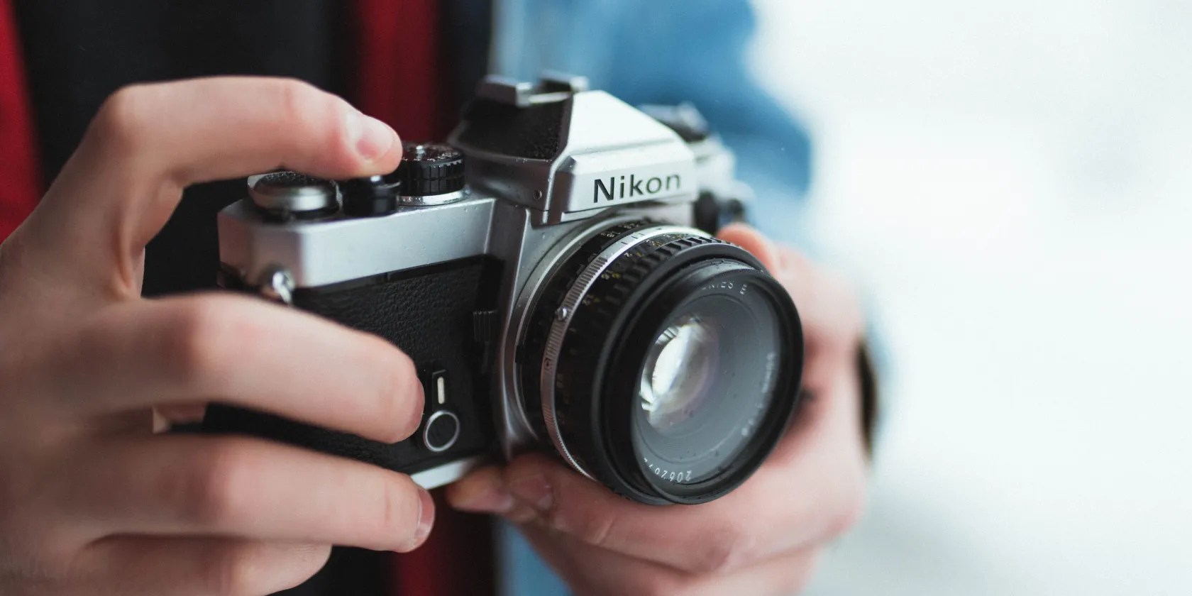 Person Holding Black and Gray Nikon Camera Photo