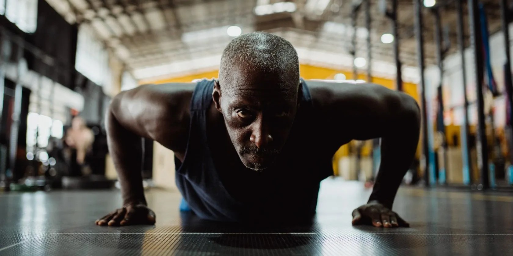 A person doing push-ups, facing the camera.