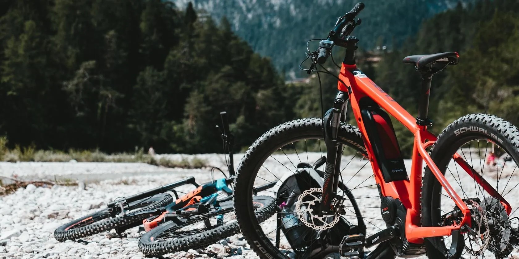 Image of two Ebikes parked on mountainous terrain