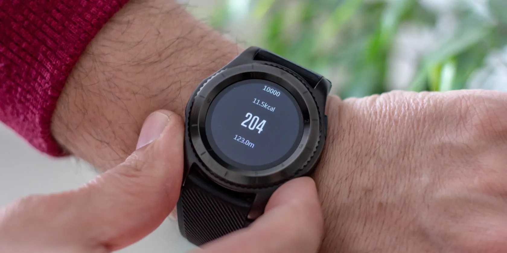 person wearing black smart fitness tracker