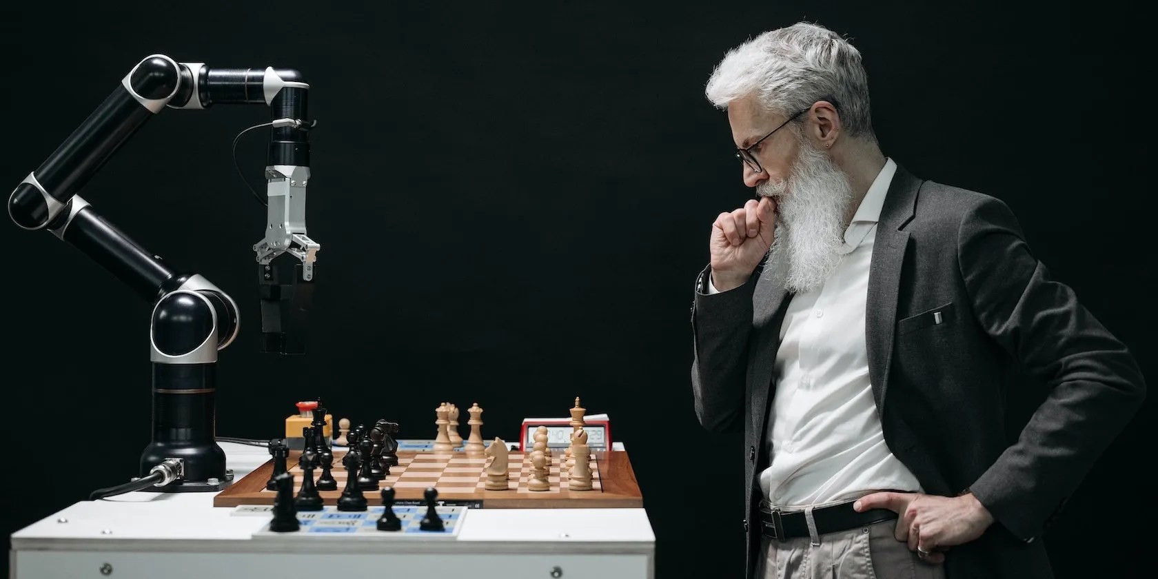 Old Man Playing Chess With a Robot Hand