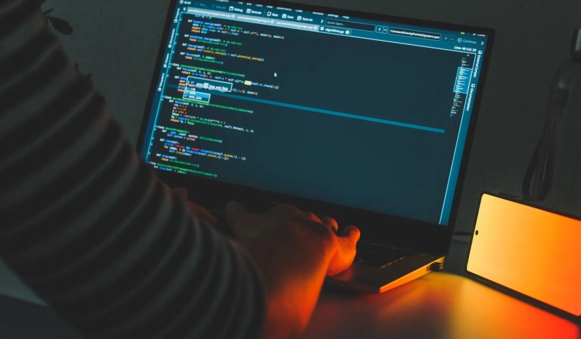 Man Operating a Laptop