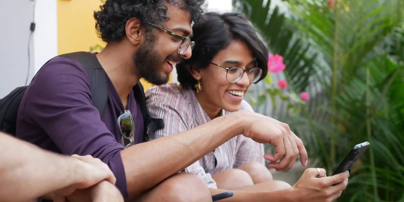 Man and Woman Operating a Mobile Phone Smiling
