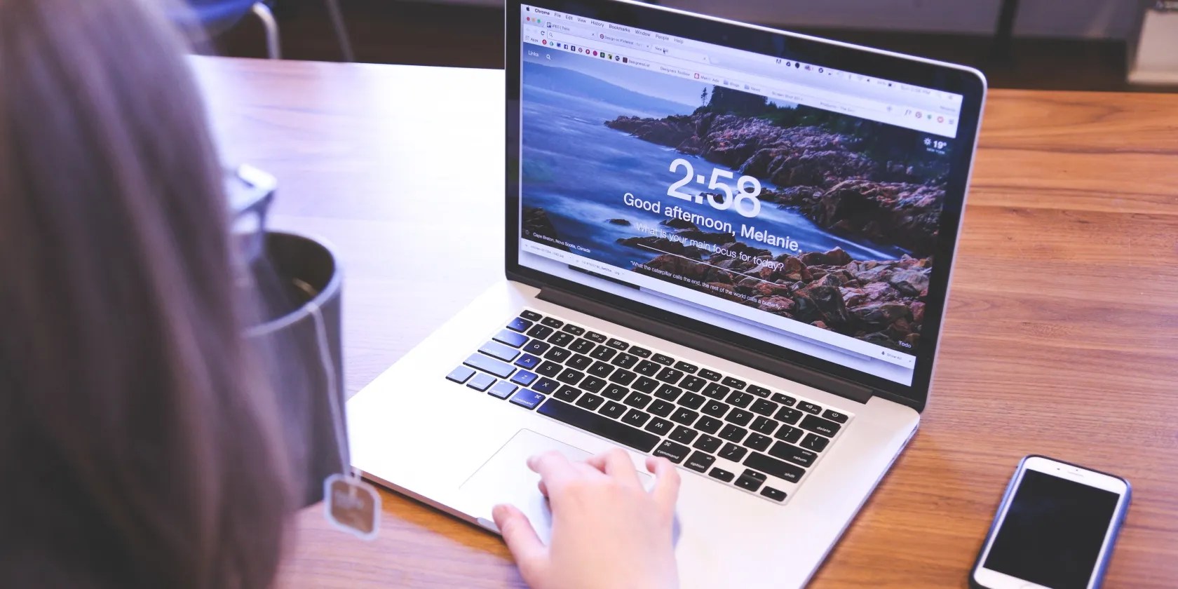 Woman Using Macbook Pro on Table Photo