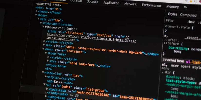 A laptop screen with HTML code on it.