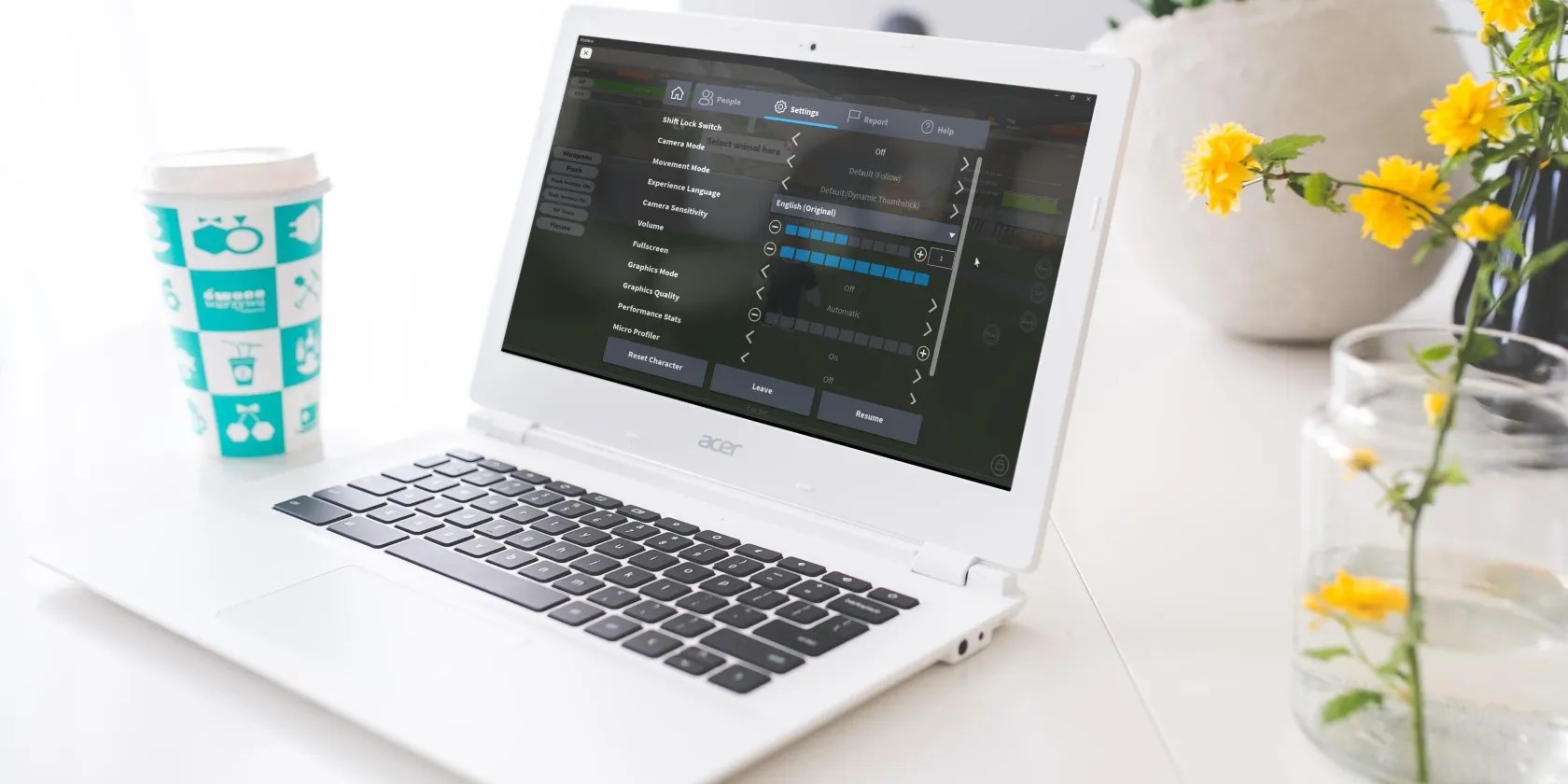 Laptop Placed on a Table Showing Roblox Settings on Windows