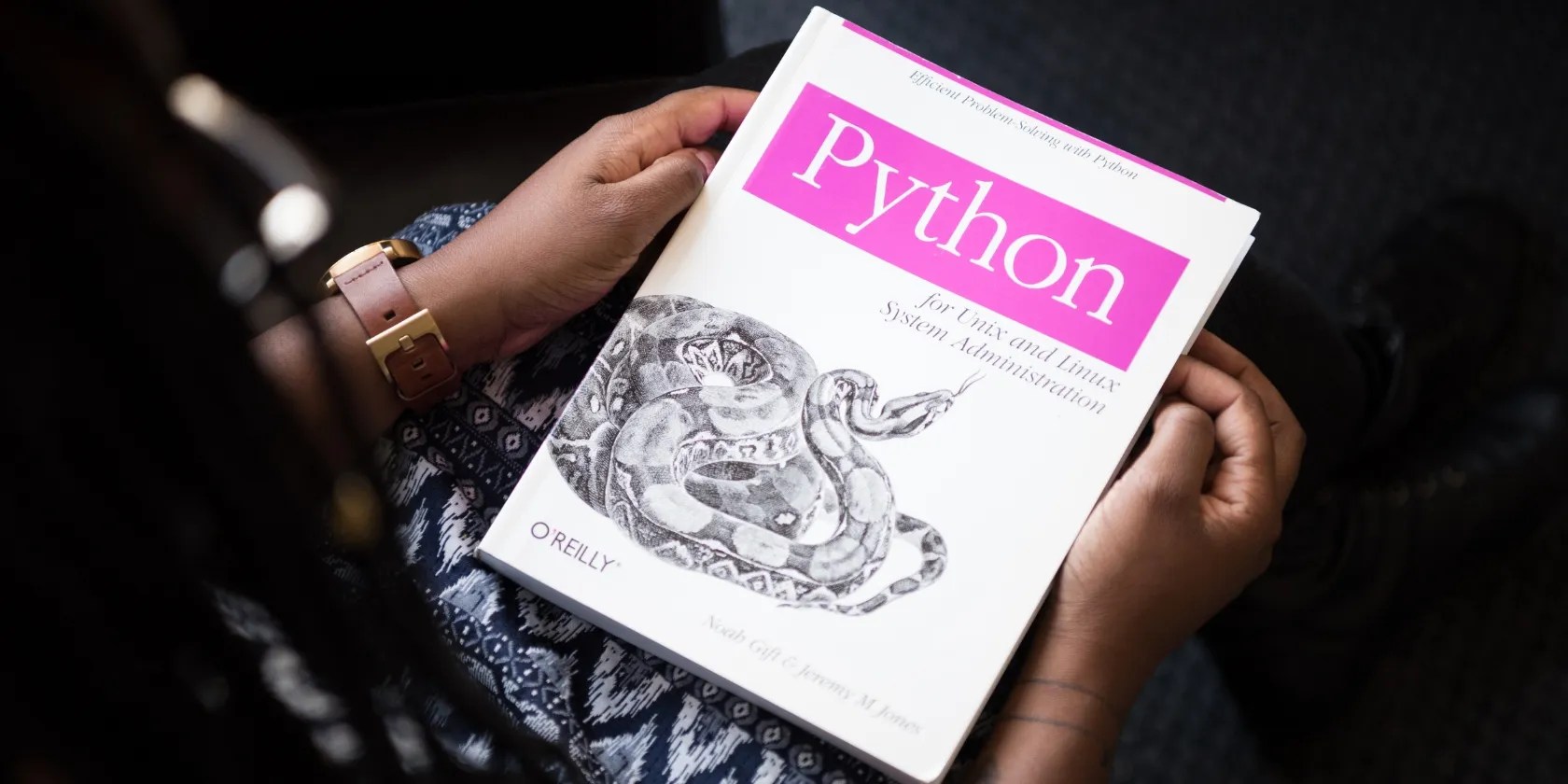 person holding python book