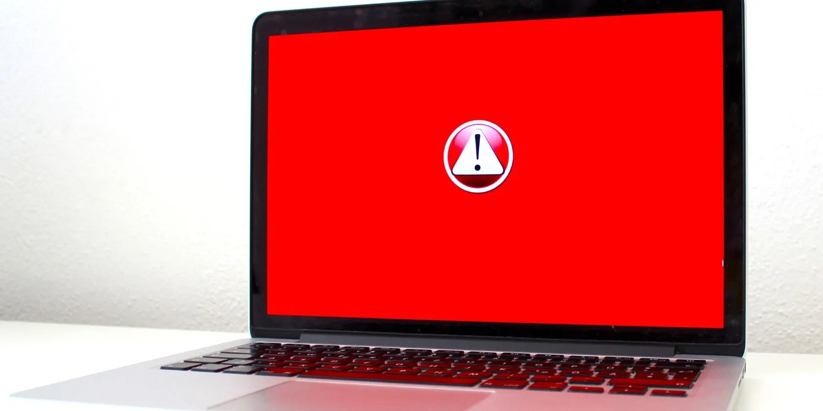 laptop with red alert icon on screen