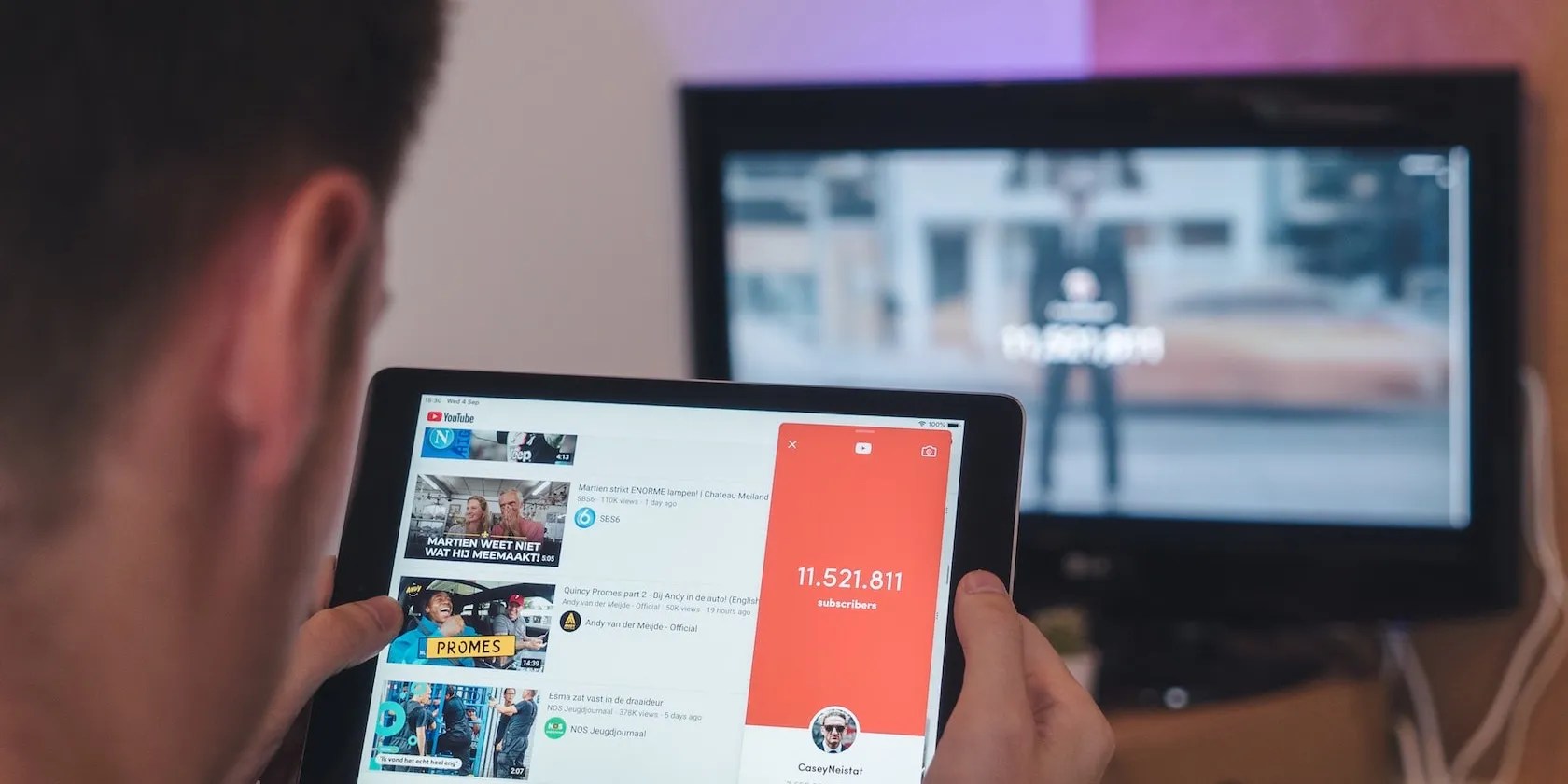 Man Browsing YouTube on Tablet