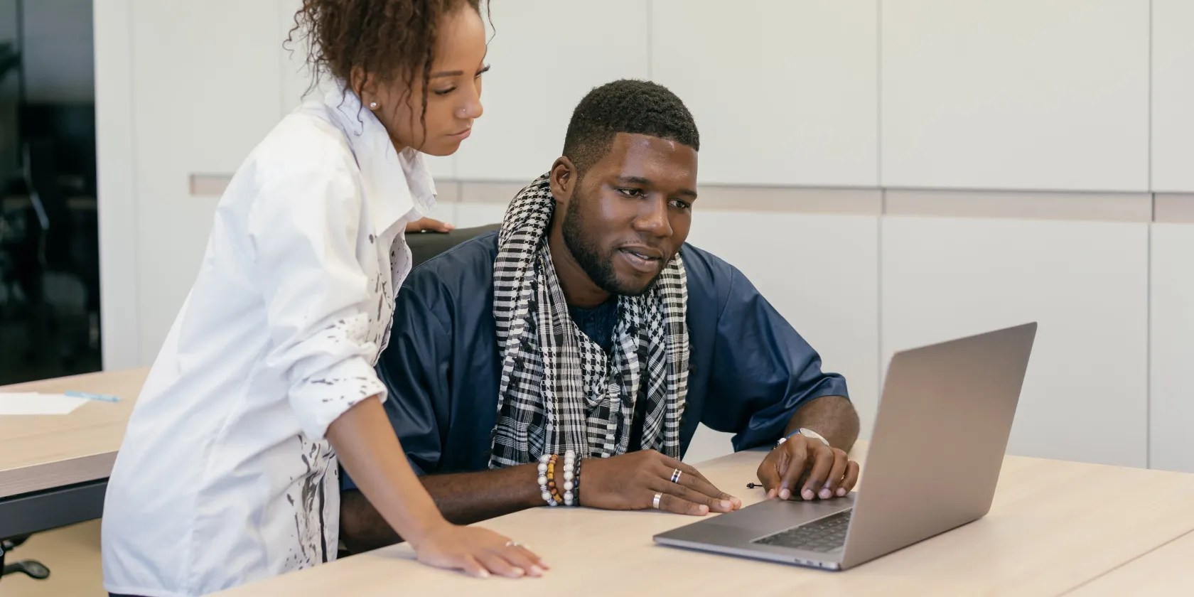 two people working together on laptop