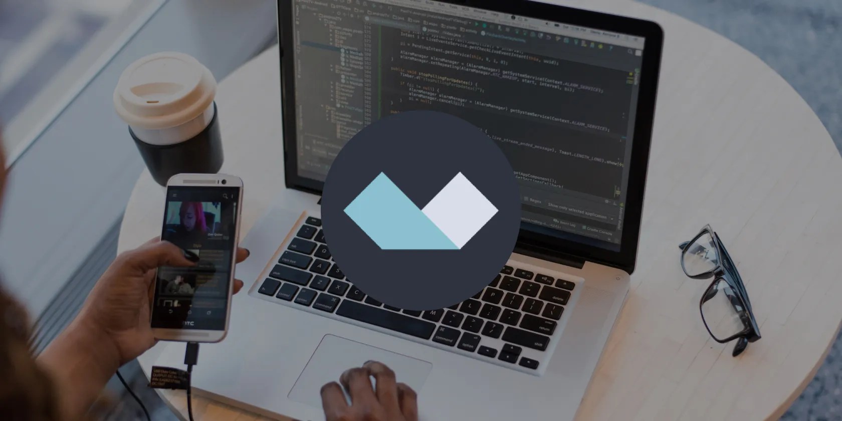 Alpine.js logo with a person working on their computer in the background