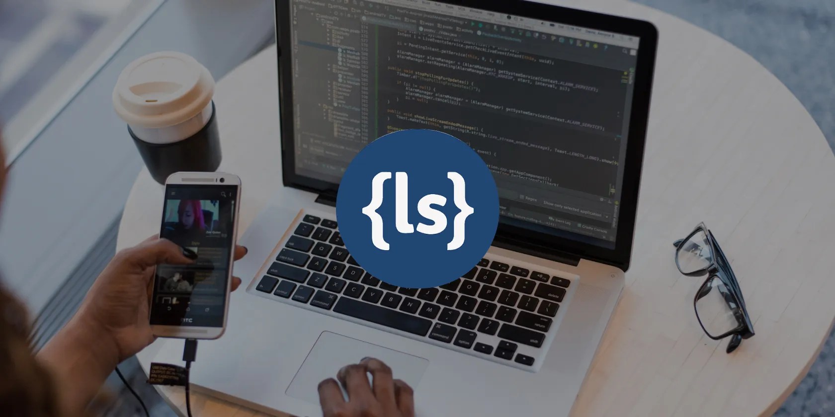 Less CSS logo overlaying an image of a person using a MacBook
