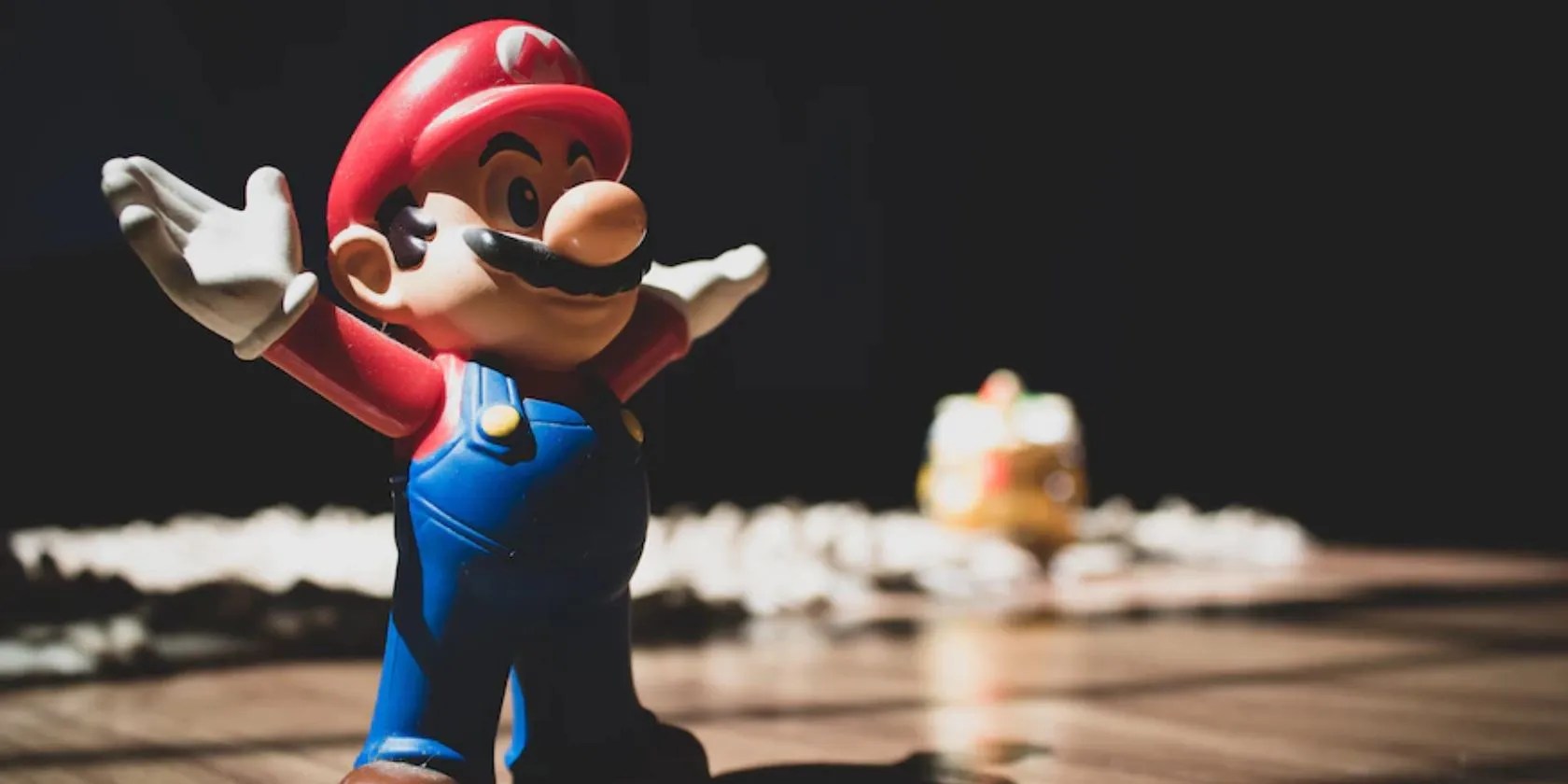 image of mario standing on a wooden floor, arms aloft