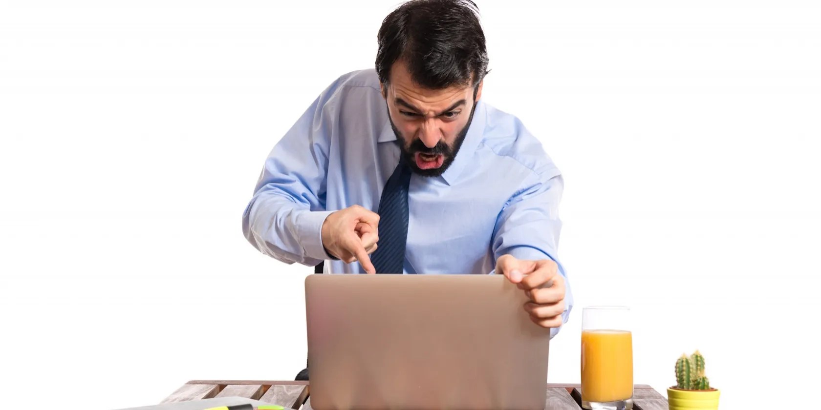 Man frustrated and pointing at his laptop