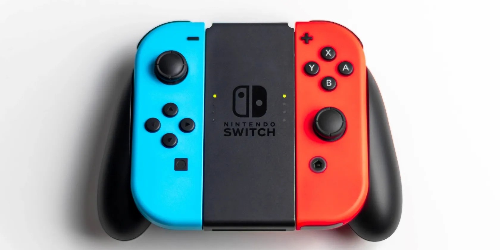 A photograph of two Nintendo Switch Joy Con attached to a controller adapter
