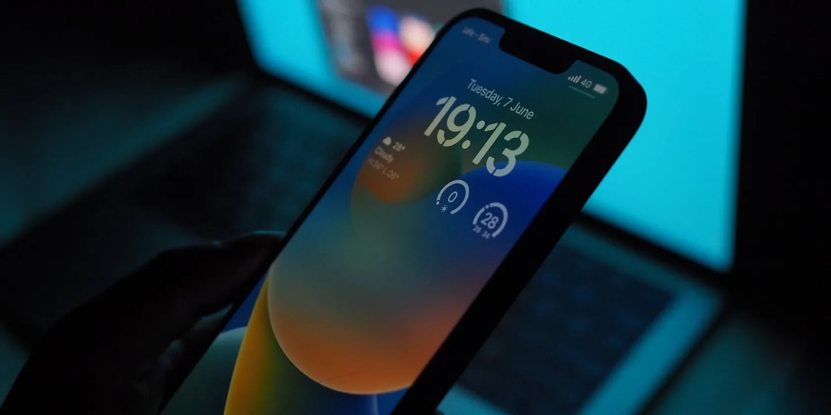 iPhone with a Laptop in the Background
