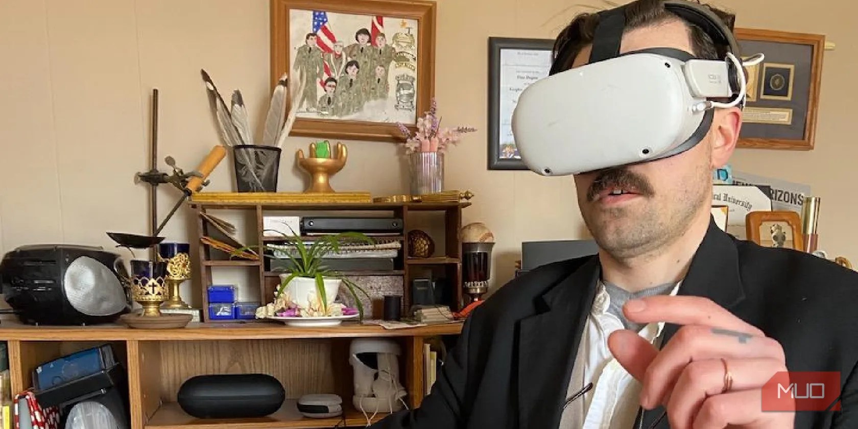 Man wearing a Quest 2, speaking and gesturing.