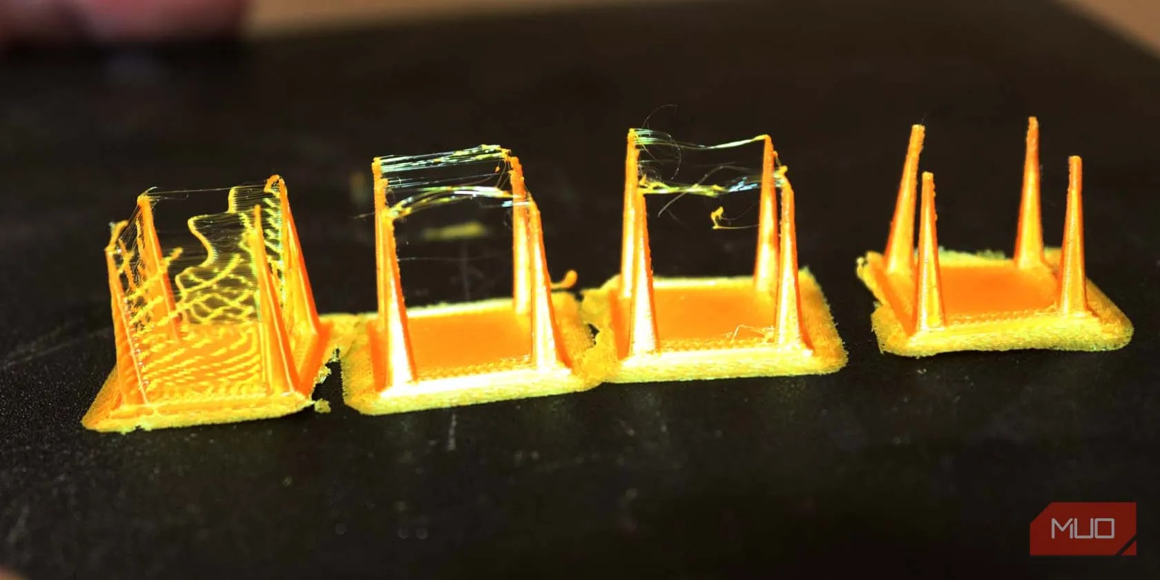 Several 3d prints covered with strings and one without