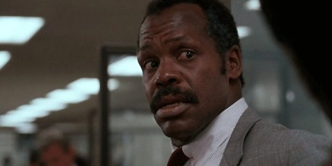 Danny Glover as Roger Murtaugh looking shocked in the office in Lethal Weapon