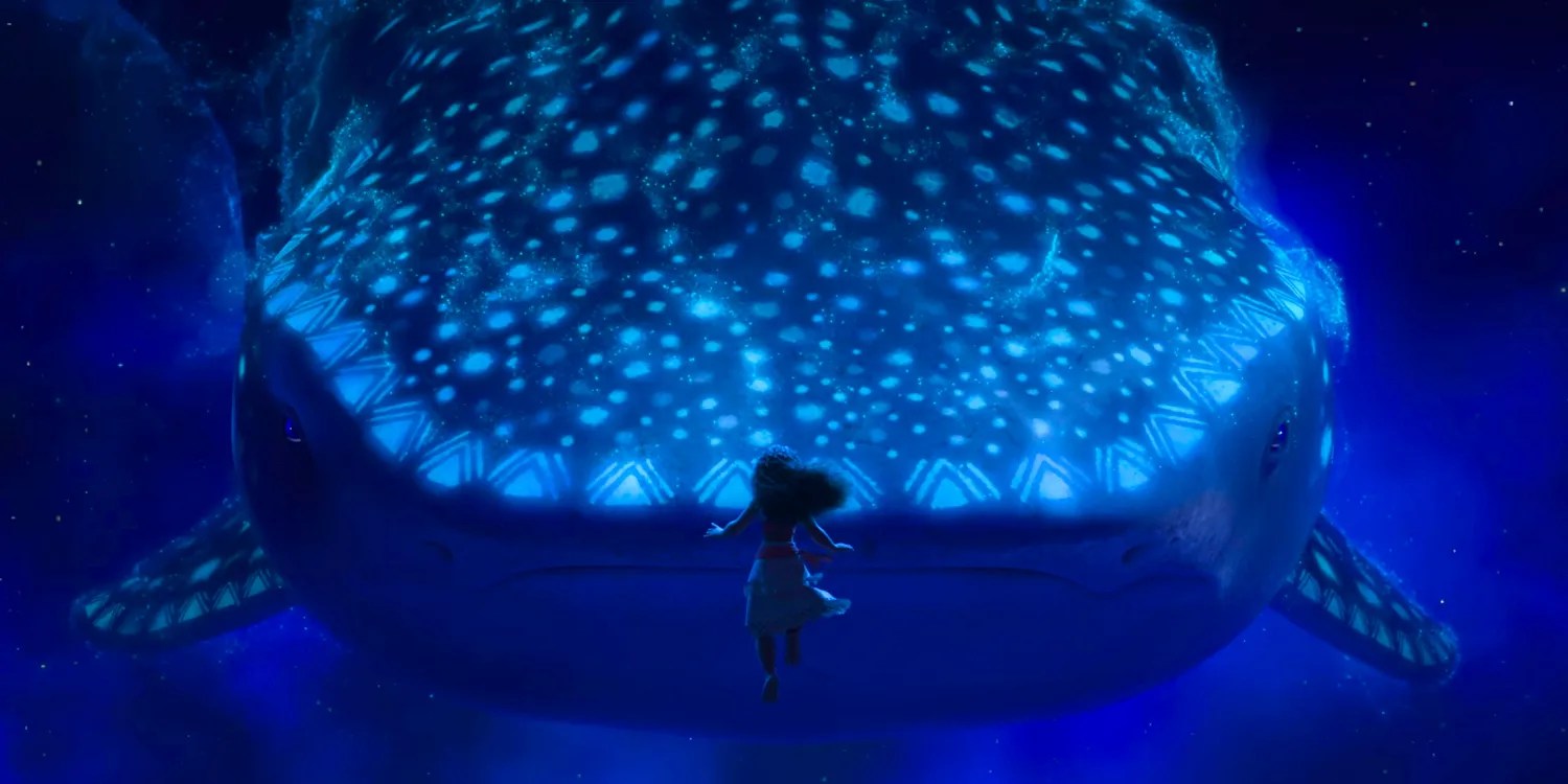 Moana floating underwater, facing a whale in Moana 2