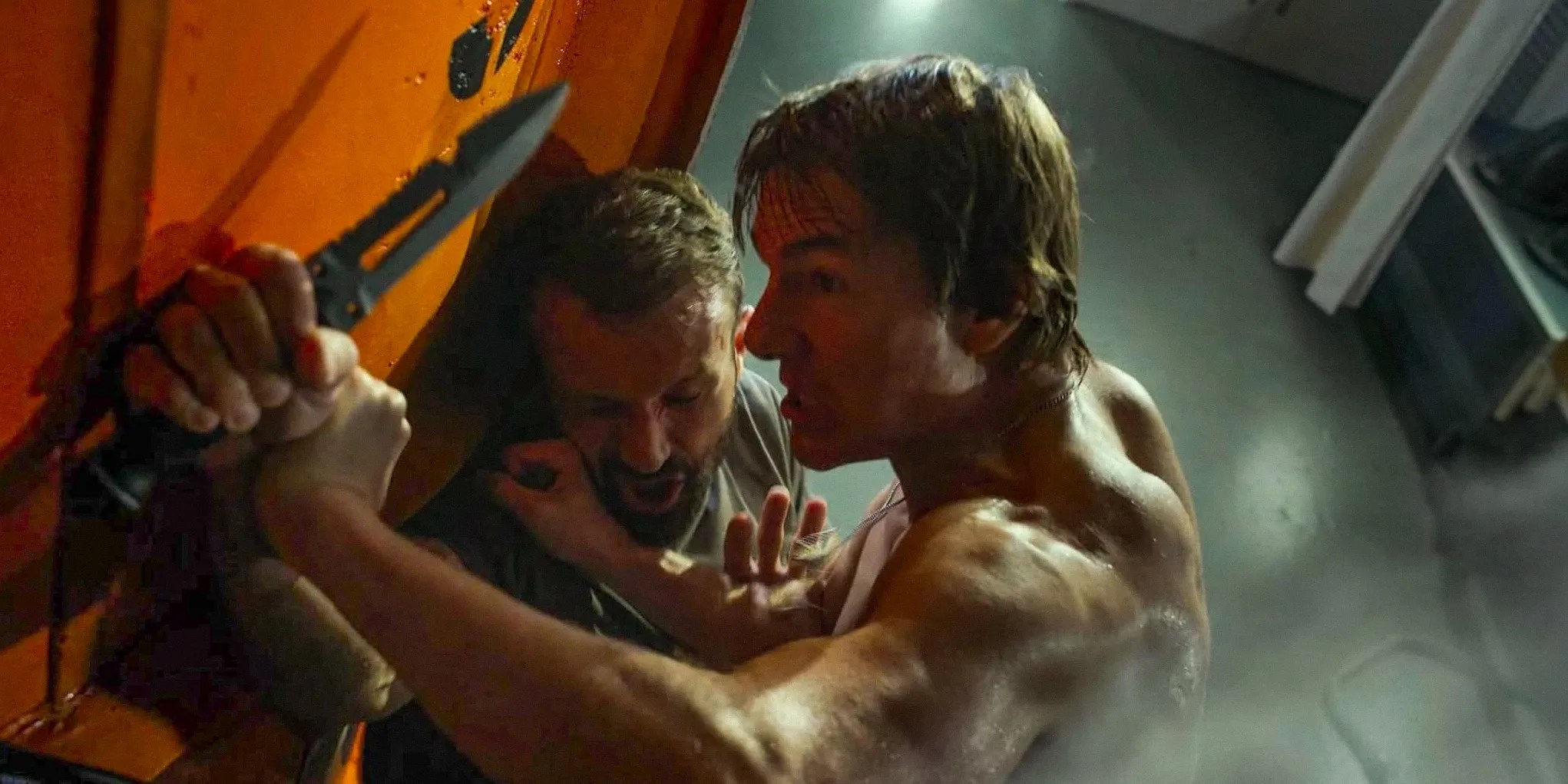 Ethan Hunt (Tom Cruise) grappling with a man wielding a knife in Mission: Impossible - The Final Reckoning