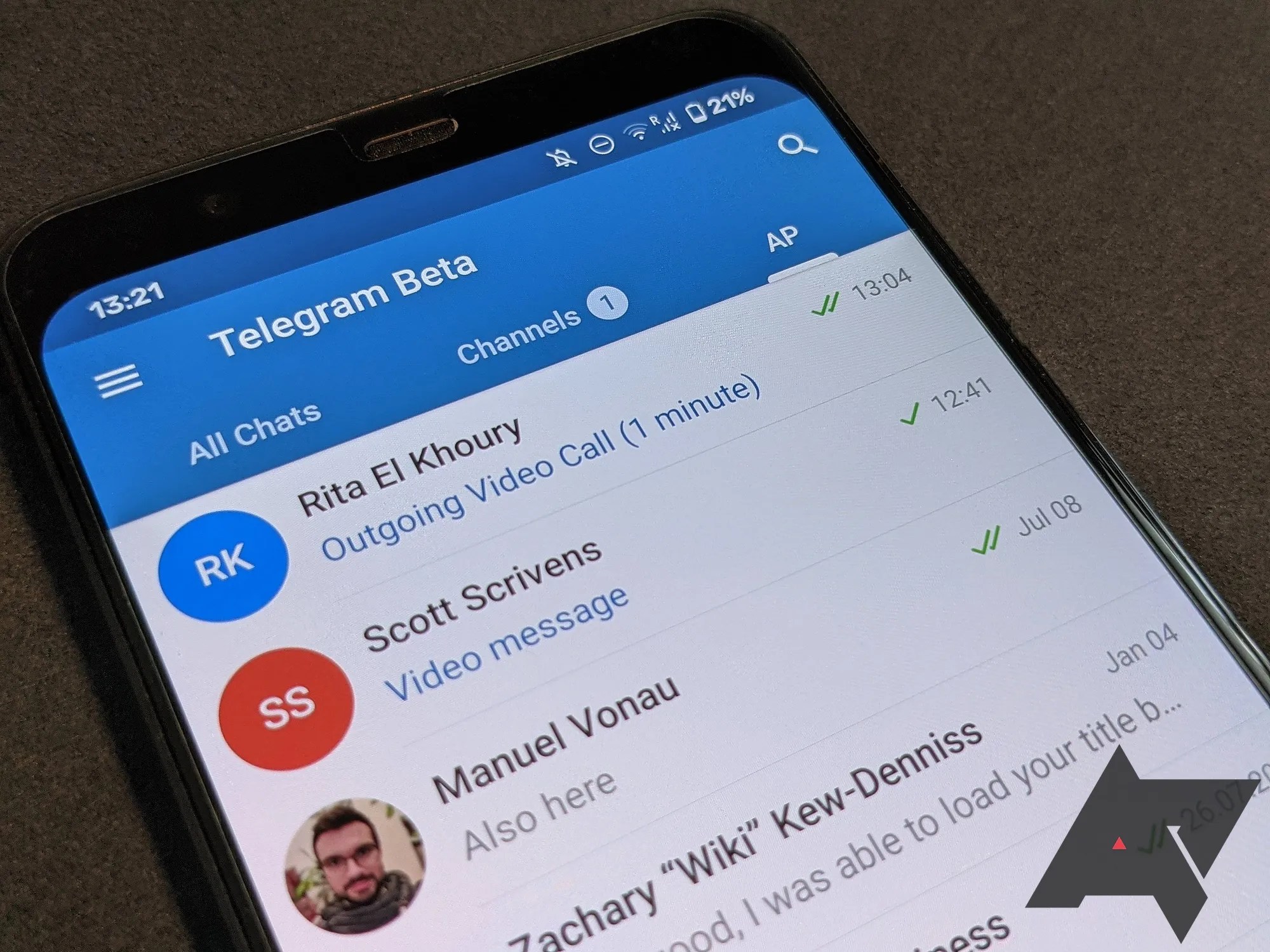 Close up of a phone with Telegram opened in the group tab.