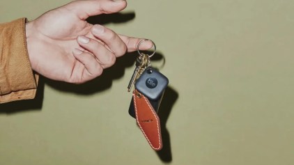 Image of a Tile Mate attached to a keyring on a green background