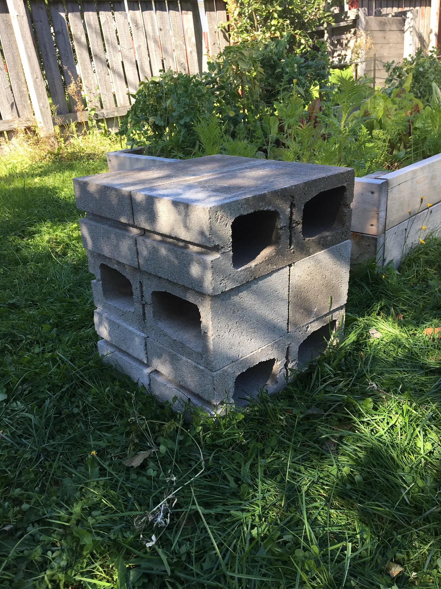 a pile of cinder blocks at the backyard