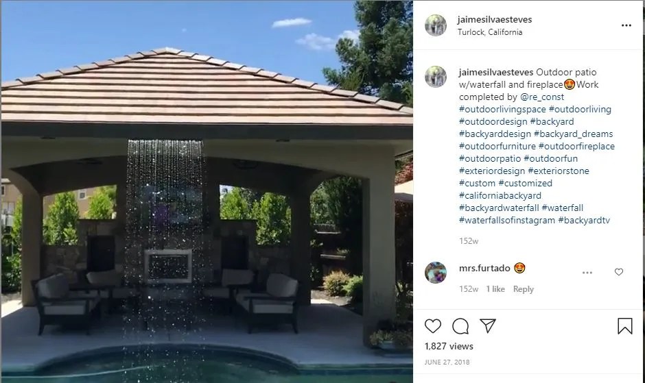 waterfall coming from gazebo wall, falling into pool below