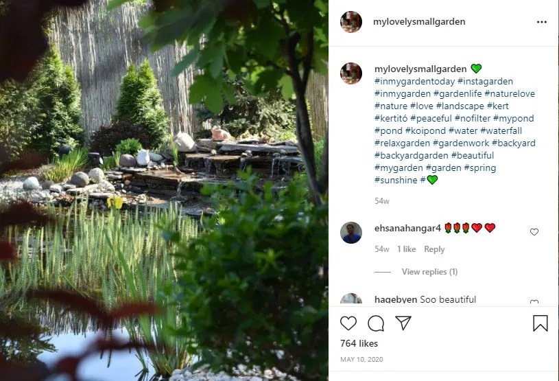 waterfall in background, made of paving stones with greenery in front