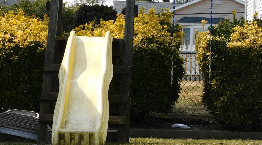 slide and swing set in backyard