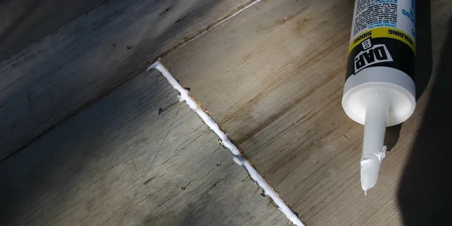 Bead of caulk and tube of caulk