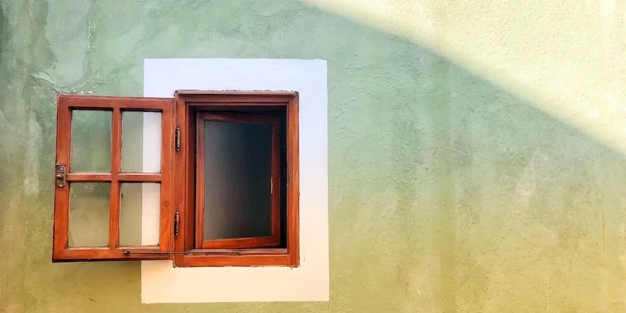 Open wooden window green wall