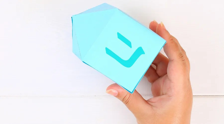 Paper dreidel with his own hands made of paper