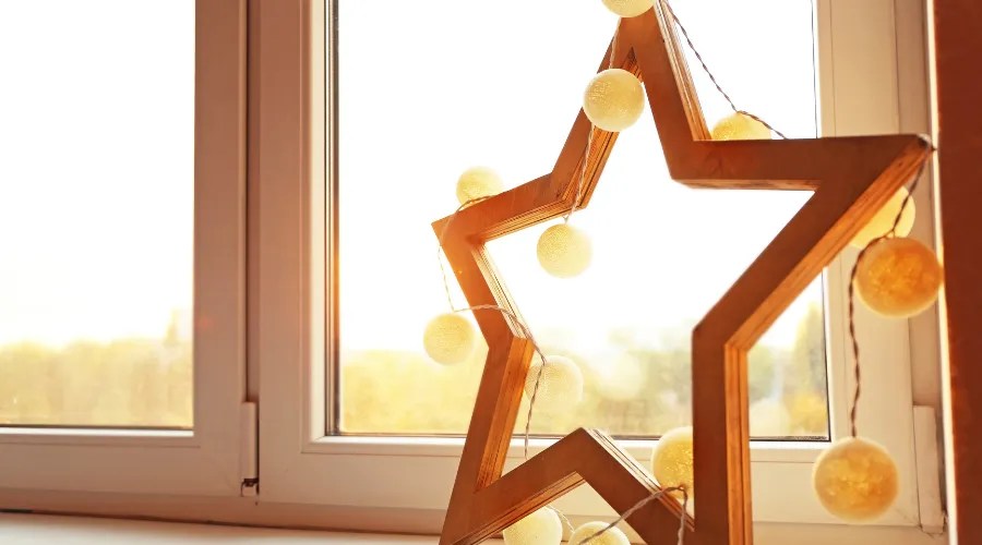 Beautiful Decorative Star with Garland on Window Sill